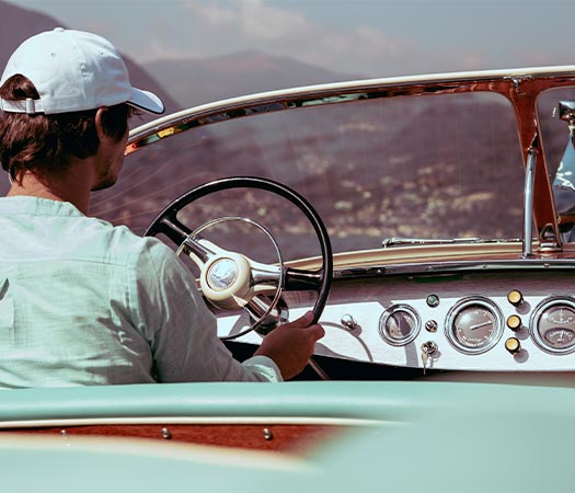 Commander of Riva Ariston Dorama luxury wooden boat sailing in Lake Como