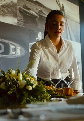 Waitress at Matteri Riva Private Deck on Lake Como serving our shipyard lunch Waitress at Matteri Riva Private Deck on Lake Como serving our shipyard lunch