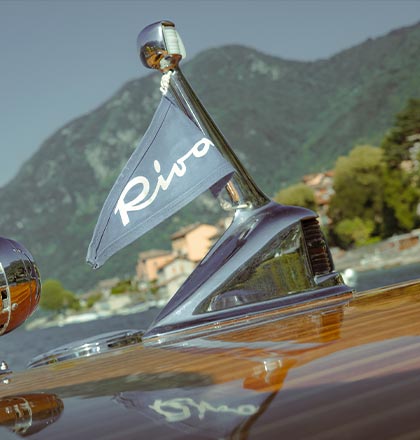 Riva Tritone luxury wooden boat sailing in Lake Como Riva flag detail